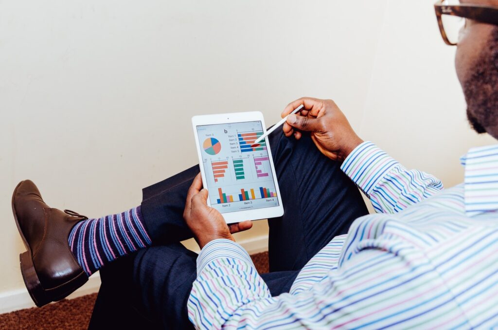 Man looking at charts on his tablet