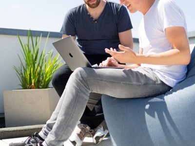 Two people looking at laptop